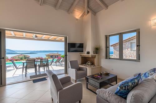 a living room with a view of the ocean at Costa Bianca Villas in Koilás