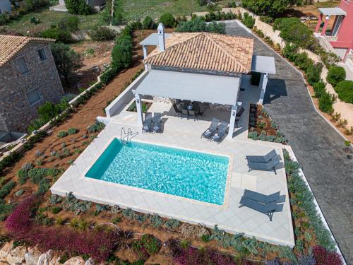 an aerial view of a house with a swimming pool at Costa Bianca Villas in Koilás