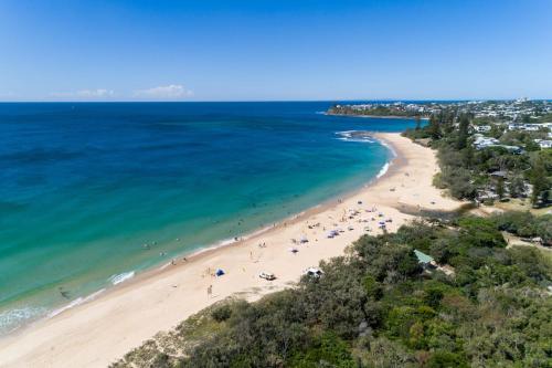 an aerial view of a beach with people on it at Coastal Getaway Across From Dicky Beach in Caloundra