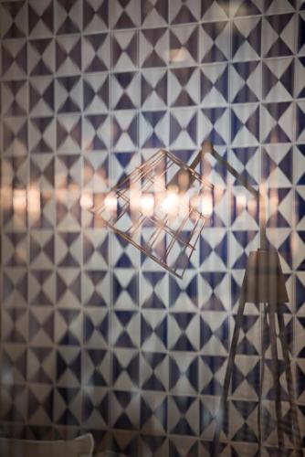 a plane hanging on a tiled wall at Hotel Casa Hintze Ribeiro in Ponta Delgada