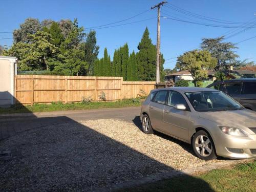 a silver car parked on the side of a road at Family-Friendly 5-Bedroom Home Near Uni & Hamilton Gardens - Sleeps 10 in Hamilton