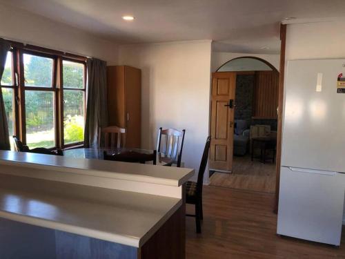 a kitchen and living room with a white refrigerator at Family-Friendly 5-Bedroom Home Near Uni & Hamilton Gardens - Sleeps 10 in Hamilton