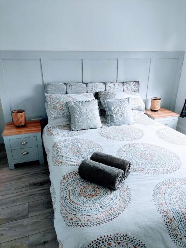 a bedroom with a bed with two pillows on it at 'Serenity in Somerset ' Self Catering House Rental Near Chard , Accomodation for Contract Workers only in Chardstock