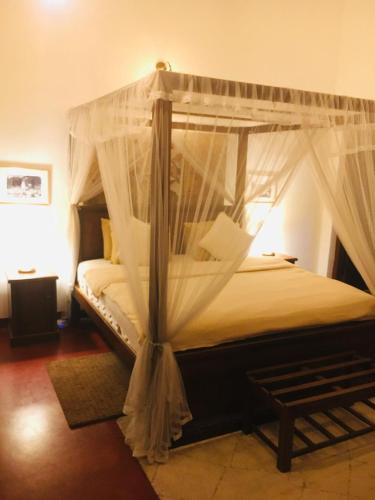 Postel nebo postele na pokoji v ubytování Colonial Residence Kandy