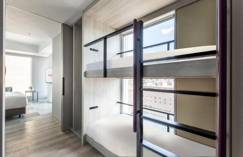 a room with a bunk bed and a window at Centara Grand Hotel Osaka in Osaka