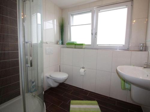 a bathroom with a toilet and a sink and a shower at Gerda in the Michaela House in Borkum
