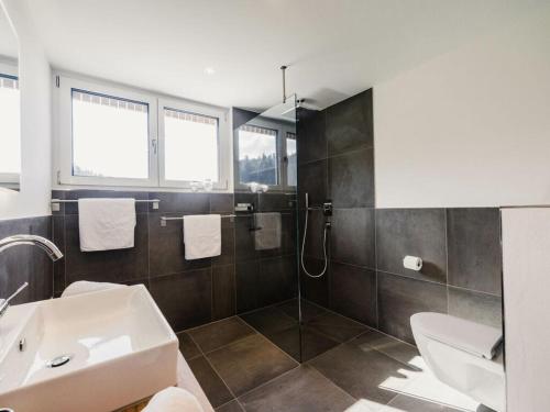 a bathroom with a sink and a toilet at Holiday apartment 3 in the holiday home Sandra in Hörbranz