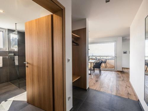 a hallway with a door leading to a room with a table at Holiday apartment 3 in the holiday home Sandra in Hörbranz