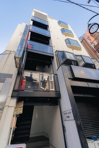 a tall building with balconies on the side of it at unito residence WASEDA in Tokyo