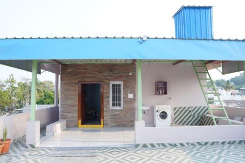 a house with a staircase and a washing machine on a balcony at Katyayani Serenity - Your Premium Homestay in Bhadrāchalam
