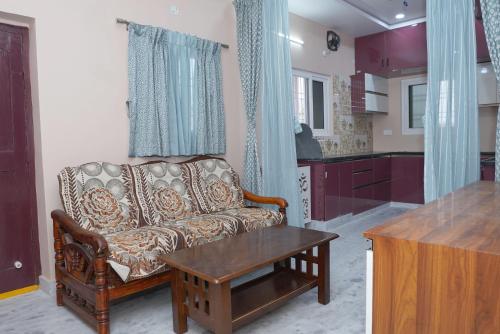 a living room with a couch and a table at Katyayani Serenity - Your Premium Homestay in Bhadrāchalam