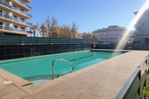 a swimming pool with a water sprinkler in a building at L'Ampolla, sol y mar in L'Ampolla