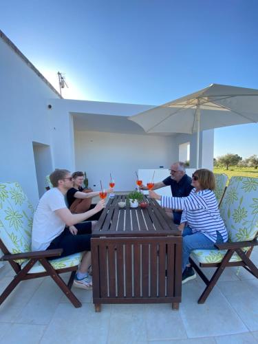 a group of people sitting around a table with drinks at Villa Filou in Santa Lucia
