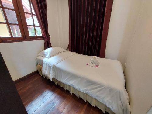 a small bed in a room with a window at Sisina Resort and Spa in Prachuap Khiri Khan