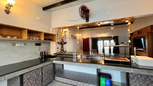 a kitchen with a counter with a large mirror at Mermaid Island Beach Resorts in Puducherry