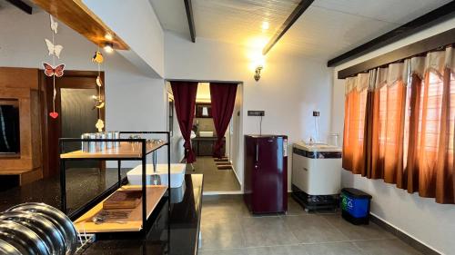 a room with a kitchen with a refrigerator at Mermaid Island Beach Resorts in Puducherry