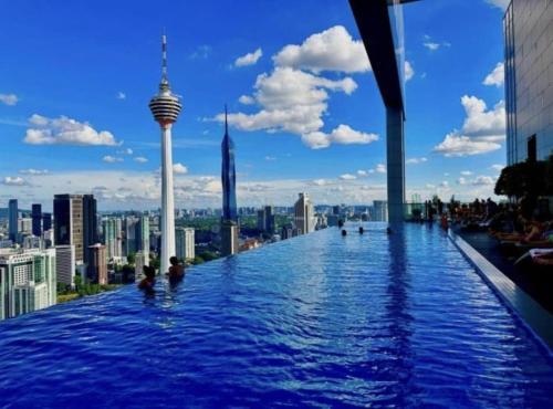 a infinity pool on the top of a building with a city at PLATINUM Suites KLCC By AR Hospitality in Kuala Lumpur
