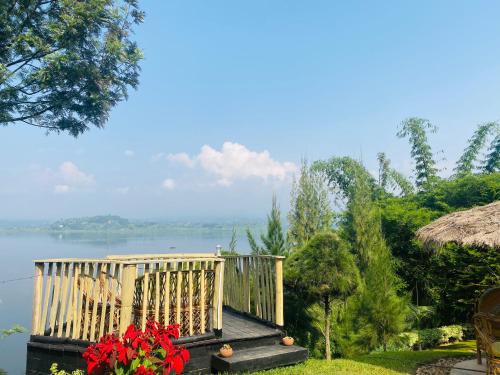 a wooden deck with a view of the water at Ruhondo Beach Resort in Ruhengeri