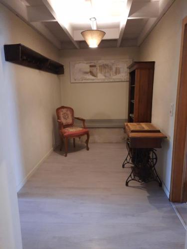 an empty room with a chair and a desk at koekoelavache holiday home in Vielsalm