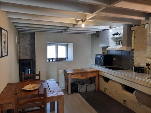 a kitchen with a wooden table and a tableasteryasteryasteryasteryasteryasteryastery at koekoelavache holiday home in Vielsalm