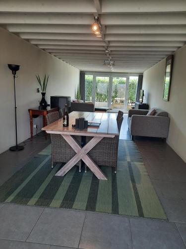a living room with a table and a couch at koekoelavache holiday home in Vielsalm