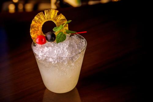 a drink sitting on a table with a garnishment at Hotel GrandBach Tokyo Ginza in Tokyo