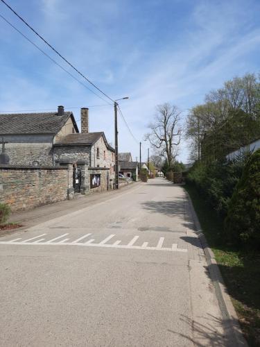 an empty street with a crosswalk in front of a building at koekoelavache holiday home in Vielsalm