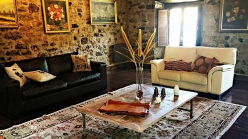 a living room with a couch and a coffee table at Hotel Rural Palacio de Galceran in Sotiello