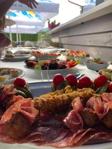 a table with many plates of food on at Pensiunea Hyperion Cormaia in Sîngeorz-Băi