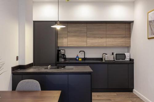 a kitchen with a sink and a microwave at Fantastic 1 Bedroom Apartment in Bolton in Bolton