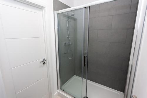 a shower with a glass door in a bathroom at Fantastic 1 Bedroom Apartment in Bolton in Bolton