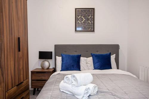 a bedroom with a bed with towels on it at Lovely Open Plan 1 Bedroom Apartment in Bolton in Bolton