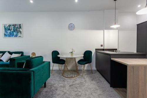 a living room with a green couch and a table at Fantastic 1 bedroom apartment in Bolton in Bolton