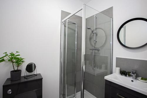 a bathroom with a glass shower and a sink at Modern 1 Bedroom Apartment in Bolton in Bolton