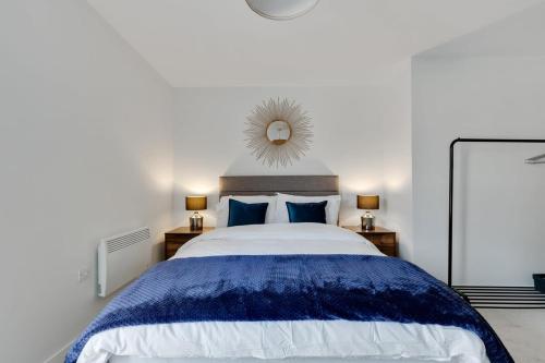 a bedroom with a large bed and a mirror at 1 Bed Modern Apartment in a Converted Mill in Leeds