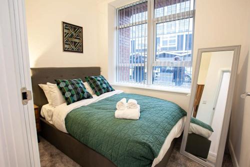a bedroom with a bed with two towels on it at Cosy 1 Bedroom Apartment in Bolton in Bolton