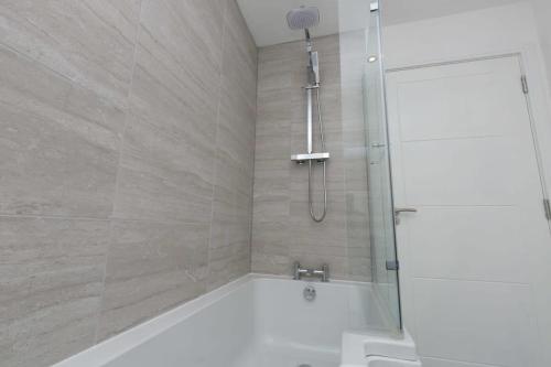 a bathroom with a shower with a bath tub at Stunning 2 Bedroom Apartment in Wallasey in Wallasey