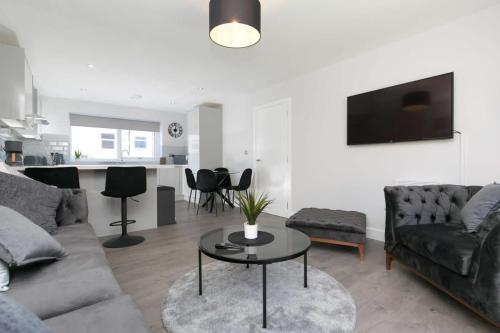 a living room with a couch and a table at Stunning 2 Bedroom Apartment in Wallasey in Wallasey