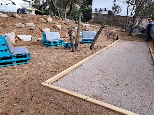two chairs and two chairs in a dirt yard at Edith et Jean-Paul in Porto-Vecchio