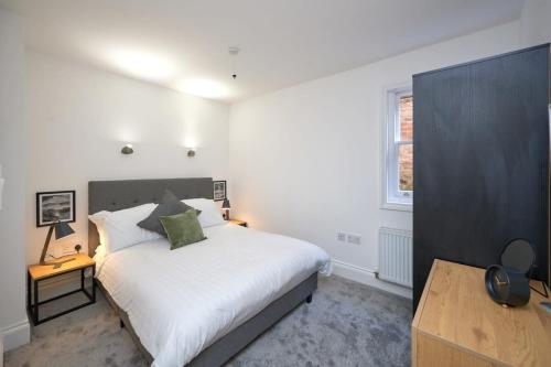 a bedroom with a large white bed and a window at Lovely 2 Bedroom Apartment in Preston in Preston