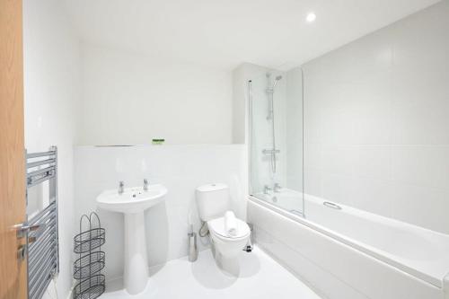 a white bathroom with a toilet and a sink at Fabulous 1 Bedroom Apartment in Central Preston in Preston