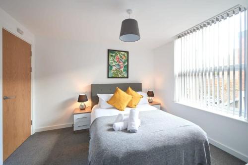 a bedroom with a bed with two white socks on it at Fabulous 1 Bedroom Apartment in Central Preston in Preston