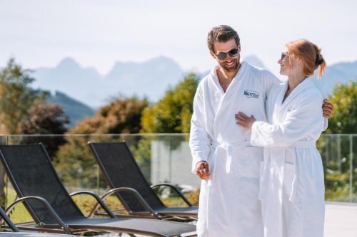 a man and a woman standing next to rows of chairs at Hotel Sperlhof in Windischgarsten