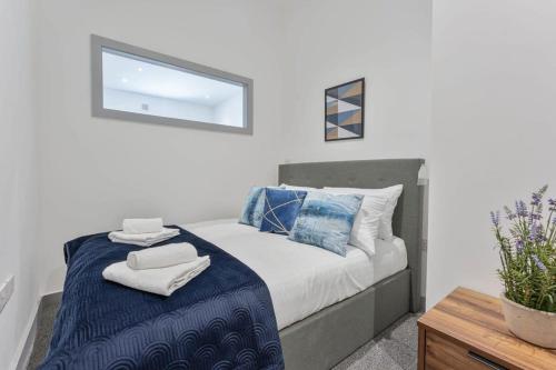 a bedroom with a bed with towels on it at Contemporary & Cosy 1 Bed Apartment in Dudley in Brierley Hill