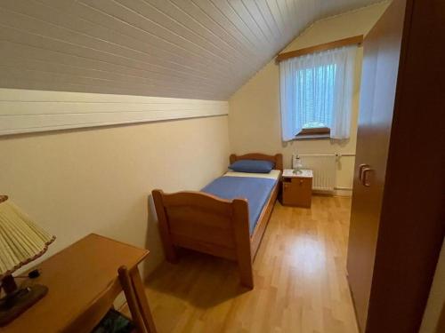 a bedroom with a bed and a table and a window at APARTMANI VISOLE in Slovenska Bistrica