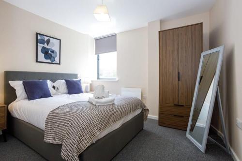 um quarto com uma cama grande e um espelho em Modern and Stylish 1 Bed Apartment Manchester em Manchester