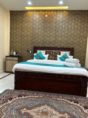 a bedroom with a large bed with blue pillows at Kashi cottage in Varanasi