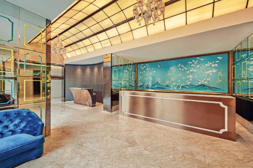 a lobby with a blue couch and an aquarium at Dorsett Shanghai in Shanghai
