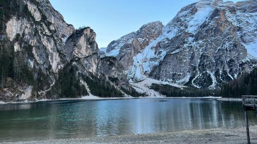 a mountain reflecting in a lake in front of a mountain at Steinwandterhof in Braies