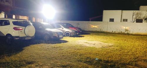 a group of cars parked in a parking lot at night at 4 Bedrooms Resort with Swimming Pool in Covelong